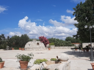 Piazzale agriturismo con pietra, alberi, cielo, nuvole
